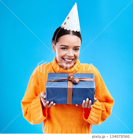 Woman, portrait smile and gift in studio for birthday present, event or celebration against a blue background. Happy female smiling and holding gifts or box for party, surprise or giving on mockup Woman, portrait smile and gift in studio for birthday present, event or celebration against a blue background. Happy female smiling and holding gifts or box for party, surprise or giving on mockup 134078560
