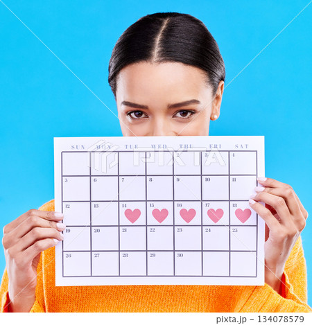 Calendar, heart and woman on blue background for period schedule, planning and menstruation in studio. Time management, strategy and eyes of girl with month poster for date, weekly planner and cycle Calendar, heart and woman on blue background for period schedule, planning and menstruation in studio. Time management, strategy and eyes of girl with month poster for date, weekly planner and cycle 134078579