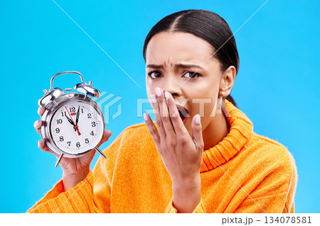 Portrait, surprise and woman with an alarm clock, late and deadline with girl against a blue studio background. Face, female model and person with time, shocked and stress with schedule and wow Portrait, surprise and woman with an alarm clock, late and deadline with girl against a blue studio background. Face, female model and person with time, shocked and stress with schedule and wow 134078581