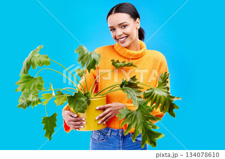 Portrait of happy woman in studio with plant, smile and happiness with house plants on blue background. Gardening, sustainable and green hobby for gen z girl on mockup for eco friendly garden shop. Portrait of happy woman in studio with plant, smile and happiness with house plants on blue background. Gardening, sustainable and green hobby for gen z girl on mockup for eco friendly garden shop. 134078610