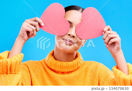 Heart eyes, cover and woman smile with happiness and excited for love, valentines day or studio emoji. Happy, loving or person on isolated blue background, creative romance paper and show care symbol 134078630