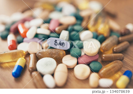 Healthcare, depression or table with medicine pills or supplements products at drugstore clinic. Pharmaceuticals background, blur or medical vitamins, stress anxiety tablets or sad medication closeup 134078639