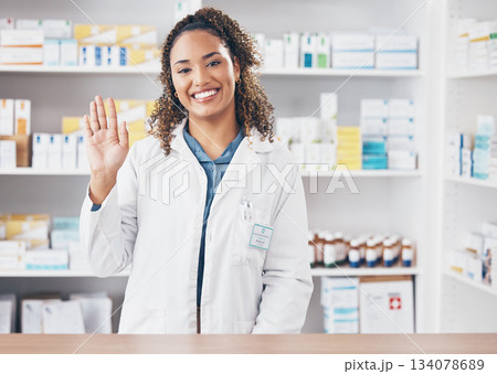 Wave, pharmacist or portrait of woman in pharmacy with smile in customer services or wellness clinic. Healthcare help desk, welcome or happy doctor with hello greeting by medication on drugstore Wave, pharmacist or portrait of woman in pharmacy with smile in customer services or wellness clinic. Healthcare help desk, welcome or happy doctor with hello greeting by medication on drugstore 134078689