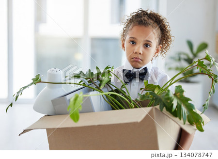 Sad, portrait and a child playing as a business person with a box of belongings after fired. Unhappy, jobless and a little girl pretending to leave an office and packing after work retrenchment 134078747
