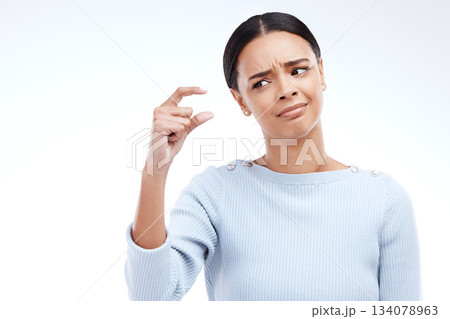 Woman, hand and small sign in studio with size, gesture or symbol against white background. Little, icon and finger emoji by girl disappointed on mockup with scale, review or opinion while isolated 134078963