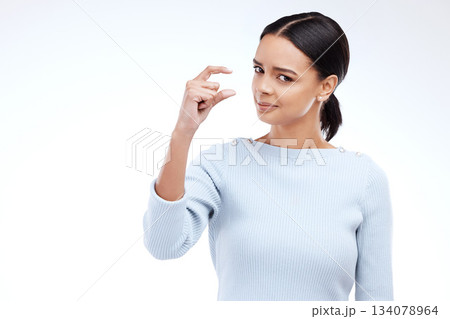 Woman portrait, hand and small sign in studio with size, gesture or symbol on white background. Little, icon and finger emoji by face of girl on mockup with scale, review or opinion while isolated 134078964