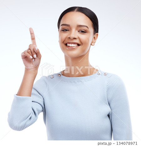 Woman face, portrait smile and pointing up at mock up sales promotion, advertising space or discount deal mockup. Brand commercial, marketing studio or product placement female on white background 134078971