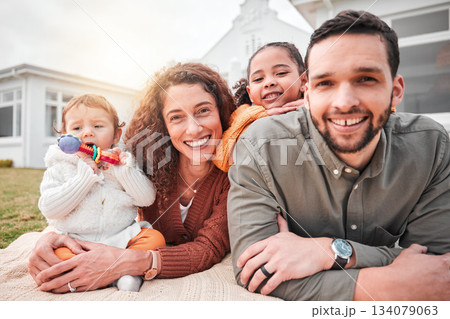 Relax, picnic and portrait of a happy family bonding outside a house feeling excited and happiness. Smile, interracial and mother with children, kids and father with care together on vacation Relax, picnic and portrait of a happy family bonding outside a house feeling excited and happiness. Smile, interracial and mother with children, kids and father with care together on vacation 134079063