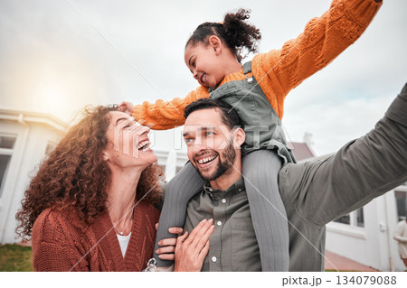 Happy family, piggy back and parents with child in yard of new house, happiness and security at home. Interracial mother, father and girl bonding in backyard together with love and smile on weekend. 134079088