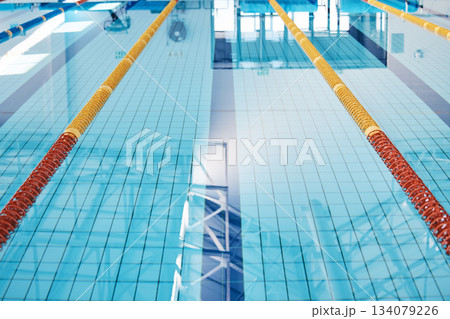 Swimming, lane and water at an indoor pool for sports, recreation and weekend fun. Empty, training and a rows for competition, sport race or practice cardio for athletes or leisure activities 134079226
