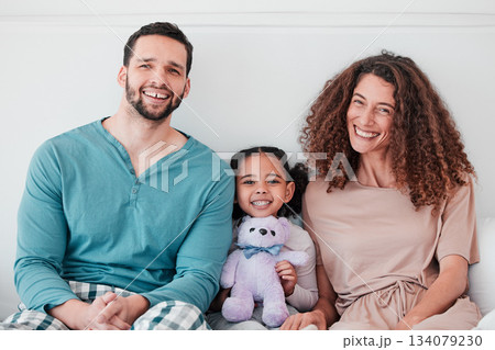 Family, portrait and parents are happy with child, relax with smile and diversity, love and care. Spending quality time together, bonding and relationship, man and woman with young girl at home 134079230
