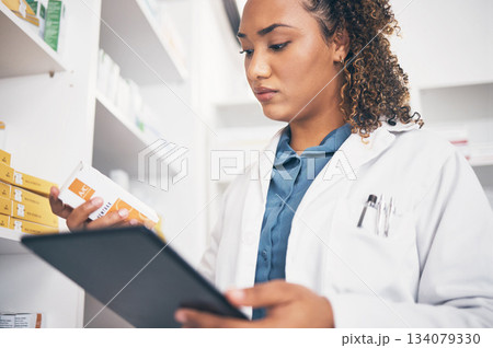 Tablet, stock and healthcare with a pharmacist woman at work to fill an online order or prescription. Medical, product and insurance with a female working as a medicine professional in a pharmacy Tablet, stock and healthcare with a pharmacist woman at work to fill an online order or prescription. Medical, product and insurance with a female working as a medicine professional in a pharmacy 134079330