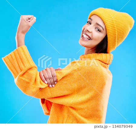 Happy, arm and portrait of a woman with muscle isolated on a blue background in a studio. Smile, strong and a girl showing muscles, power and motivation for exercise on a backdrop for confidence Happy, arm and portrait of a woman with muscle isolated on a blue background in a studio. Smile, strong and a girl showing muscles, power and motivation for exercise on a backdrop for confidence 134079349