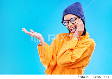 Woman palm, happiness and portrait in a studio with promotion and announcement. Excited, isolated and blue background with mockup of a gen z girl and cool young female show marketing with smile 134079354
