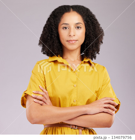 Serious, woman and portrait in studio, arms crossed and background for style, confidence and fashion. Focused female model in yellow dress with attitude, empowerment and pride of trendy personality Serious, woman and portrait in studio, arms crossed and background for style, confidence and fashion. Focused female model in yellow dress with attitude, empowerment and pride of trendy personality 134079756