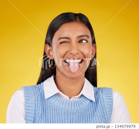 Funny, emoji and woman with tongue out, happy and cheerful against a studio background. Female, stress relief and girl with facial expression, humor and goofy action for joy, crazy and happiness 134079979