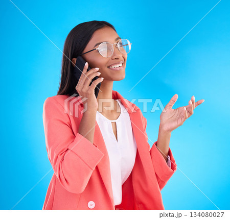 Happy business woman, phone call and conversation for communication or consulting against a blue studio background. Creative female employee talking on mobile smartphone in discussion for startup Happy business woman, phone call and conversation for communication or consulting against a blue studio background. Creative female employee talking on mobile smartphone in discussion for startup 134080027
