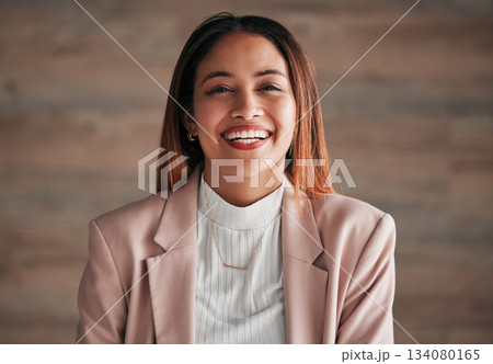 Portrait, happy and a business woman on a wooden background in studio with a positive mindset. Face, smile and motivation with a carefree young female employee feeling cheerful for a corporate career Portrait, happy and a business woman on a wooden background in studio with a positive mindset. Face, smile and motivation with a carefree young female employee feeling cheerful for a corporate career 134080165