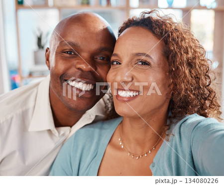 Selfie, happy and portrait of couple in home for bonding, quality time and relax together in living room. Love, relationship and interracial man and woman smile for picture for social media or memory 134080226