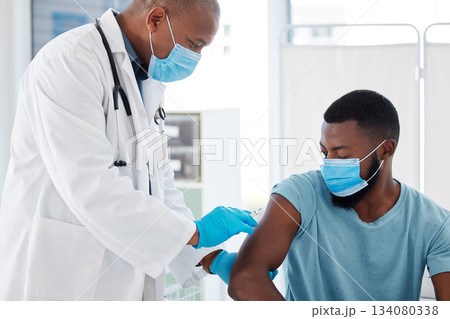 Doctor, black man and vaccine injection for covid safety, immunity and prevention. Face mask, healthcare and medical professional with vaccination syringe, cure or medicine for patient in clinic. Doctor, black man and vaccine injection for covid safety, immunity and prevention. Face mask, healthcare and medical professional with vaccination syringe, cure or medicine for patient in clinic. 134080338