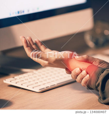 Woman, hands and wrist pain by computer from carpal tunnel syndrome or overworking at night by office desk. Hand of female holding painful arm area or pressure by PC from working late at workplace Woman, hands and wrist pain by computer from carpal tunnel syndrome or overworking at night by office desk. Hand of female holding painful arm area or pressure by PC from working late at workplace 134080407