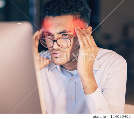 Man, headache and computer in stress, burnout or suffering pain at night by office desk. Businessman employee rubbing head or touching painful area by desktop PC feeling overworked at workplace 134080409