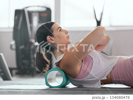 Foam roller, gym and woman doing back stretching for fitness, relief and training. Yoga, flexibility and wellness of a female doing pilates and physiotherapy for sport and breathing balance at a club 134080478