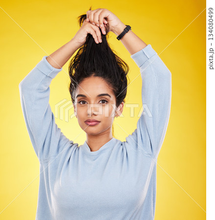 Portrait, hair care and beauty of woman in studio isolated on a yellow background. Natural, balayage and female model with long hairstyle growth, serious cosmetics and aesthetics for salon treatment Portrait, hair care and beauty of woman in studio isolated on a yellow background. Natural, balayage and female model with long hairstyle growth, serious cosmetics and aesthetics for salon treatment 134080499