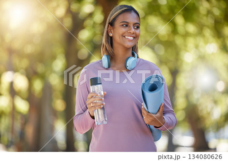 Fitness, woman and smile for yoga, park or healthy wellness and lifestyle in nature outdoors. Happy female yogi smiling with water bottle, mat and headphones for calm exercise, training or workout Fitness, woman and smile for yoga, park or healthy wellness and lifestyle in nature outdoors. Happy female yogi smiling with water bottle, mat and headphones for calm exercise, training or workout 134080626