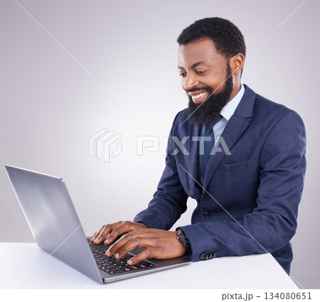 Happy black man, business and laptop in studio for planning, corporate research and internet. Male employee, computer typing and background for website connection, online stocks and digital trader 134080651