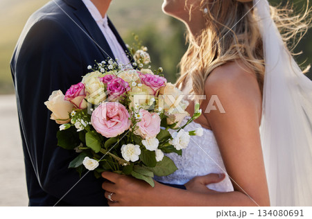 Flower bouquet, marriage hug and wedding ceremony couple for unity commitment, romantic trust or union event. Bridal flowers, love and body embrace of groom, bride or fiance in solidarity and support Flower bouquet, marriage hug and wedding ceremony couple for unity commitment, romantic trust or union event. Bridal flowers, love and body embrace of groom, bride or fiance in solidarity and support 134080691