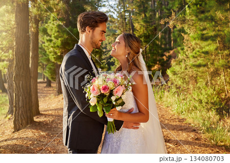 Love, bride and groom outdoor, happiness and affection with embrace, celebration and commitment. Romantic, man and woman on wedding day, forest and trust with romance, bonding and loving together 134080703