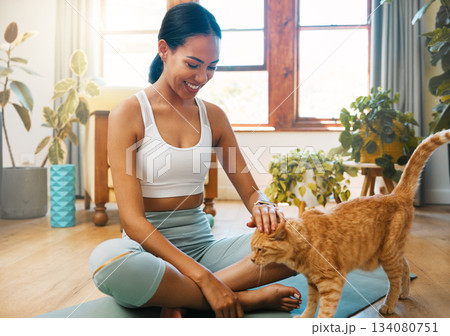 Fitness, yoga or happy woman bonding with cat or pet animal relaxing for wellness or healthy lifestyle. Smile, calm or zen girl loves caring, quality time or playing with kitten or kitty at home 134080751