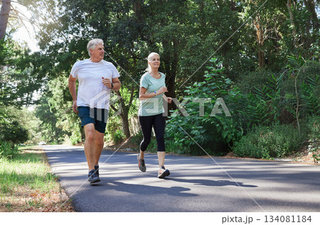 Fitness, senior and a couple running in a park for cardio, retirement exercise and movement. Happy, morning and an elderly man and woman jogging for health, training and active together in nature 134081184