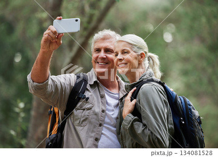 Selfie, hiking and happy mature couple of friends in forest adventure, journey and outdoor health with happy blog update. Nature, travel and trekking people in woods together and profile picture post 134081528