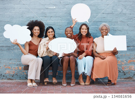 Portrait, speech bubble and diversity with business women outdoor, holding blank space for text. Collaboration, social media and communication with a happy female employee team sitting on a bench 134081656