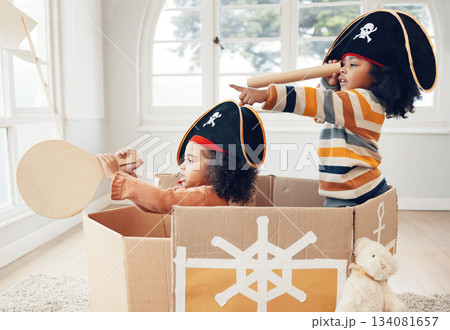 Pirate, box and playing with children in living room for bonding, imagine and creative. Happy, youth and siblings with girls sailing in cardboard ship in family home for relax, fantasy and games 134081657