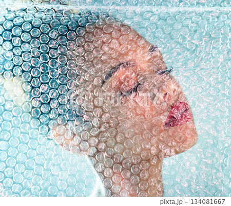 Beauty, plastic and makeup with black woman and bubble wrap for package, creative and cosmetics. Self care, confidence and youth with girl model and red lipstick for facial, art and glow in studio 134081667