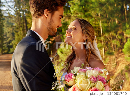 Love, bride and groom with smile, outdoor and cheerful for special day, loving and bonding. Romance, man and woman on wedding day, passionate and affectionate in nature, forest or celebration outside 134081740