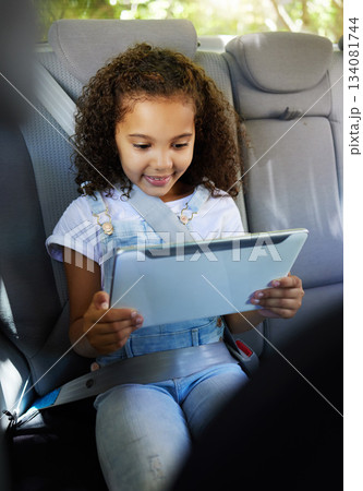 Happy, watching and a child in a car with a tablet for a movie, cartoons or video. Smile, travel and a girl sitting in a vehicle with tech, streaming online and enjoying a film for entertainment Happy, watching and a child in a car with a tablet for a movie, cartoons or video. Smile, travel and a girl sitting in a vehicle with tech, streaming online and enjoying a film for entertainment 134081744