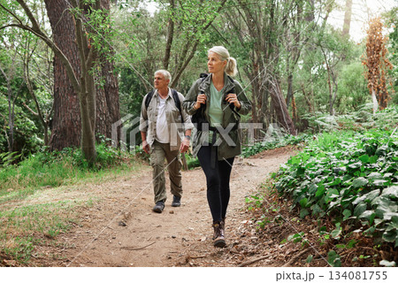 Nature, forest and senior couple hiking for health, wellness and cardio exercise outdoor. Travel, trail adventure and elderly man and woman in retirement trekking in the woods for a hobby or workout. Nature, forest and senior couple hiking for health, wellness and cardio exercise outdoor. Travel, trail adventure and elderly man and woman in retirement trekking in the woods for a hobby or workout. 134081755