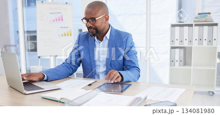Black man, business and laptop for corporate planning, strategy or communication at the office desk. African American male CEO working on computer for company statistics, marketing or schedule tasks Black man, business and laptop for corporate planning, strategy or communication at the office desk. African American male CEO working on computer for company statistics, marketing or schedule tasks 134081980