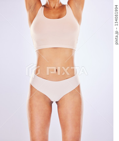 Body, woman and stomach for healthy lifestyle in studio as motivation for weight loss, diet or sports fitness. Female underwear model on a white background for abdomen, gut health or tummy wellness Body, woman and stomach for healthy lifestyle in studio as motivation for weight loss, diet or sports fitness. Female underwear model on a white background for abdomen, gut health or tummy wellness 134081994
