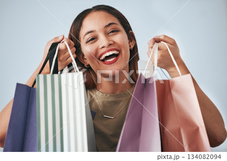 Portrait, happy woman and shopping bag isolated on studio background wealth, financial freedom or sales promotion. Retail, fashion and beauty face of biracial person or customer with paper bags offer Portrait, happy woman and shopping bag isolated on studio background wealth, financial freedom or sales promotion. Retail, fashion and beauty face of biracial person or customer with paper bags offer 134082094