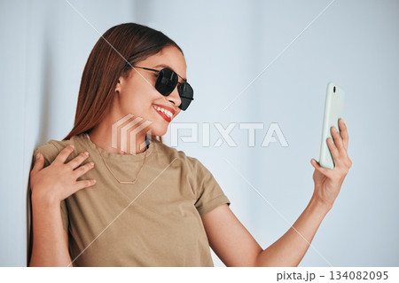 Woman, wall and sunglasses in selfie with cellphone, smile and excited with fashion for summer. Girl, student and influencer with social media app, photography and profile picture with happiness Woman, wall and sunglasses in selfie with cellphone, smile and excited with fashion for summer. Girl, student and influencer with social media app, photography and profile picture with happiness 134082095
