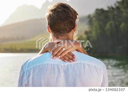 Engagement, hug and couple by lake for romantic holiday, vacation and honeymoon in nature together. Love, proposal mockup and hands of woman holding man for embrace, hugging and affection outdoors Engagement, hug and couple by lake for romantic holiday, vacation and honeymoon in nature together. Love, proposal mockup and hands of woman holding man for embrace, hugging and affection outdoors 134082107