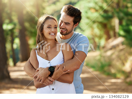 Couple hug in nature park, happy and relationship with love and trust, travel and adventure. Young people in forest, outdoor and happiness together with smile, embrace with commitment and care 134082129