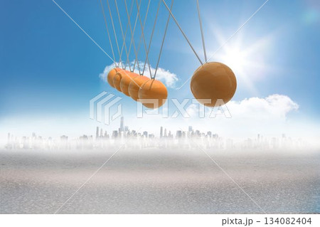 Newtons cradle above city in desert 134082404