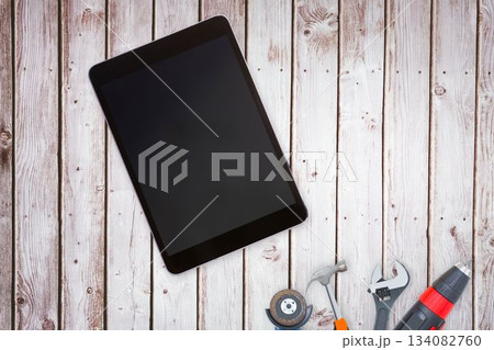 Tools and tablet on wooden background 134082760