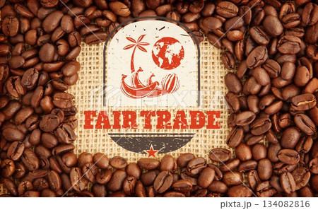 Flat-lay composition is showing fair trade emblem on burlap with coffee beans around edges 134082816